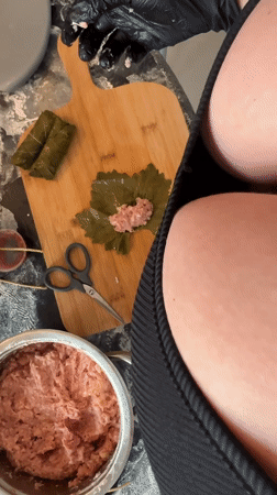 Woman prepares traditional stuffed grape leaves in Kiryat Bialik