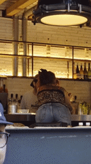 Intimate moment captured between bartender and customer in Barcelona