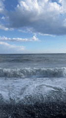 Pebble beach, waves, and shifting skies from every angle