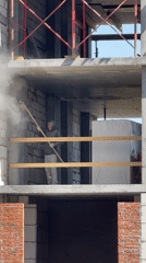 Construction worker smooths wall at building site in Izhevsk