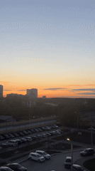 Perm resident documents evening routine, sunset views from apartment