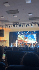Female vocalist performs with string orchestra in Izhevsk auditorium