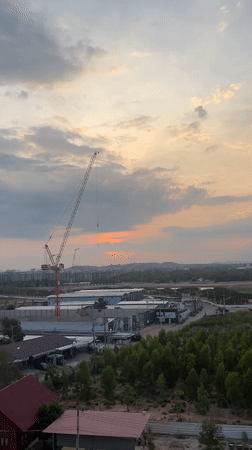 Sunset view captured over red-roofed structures in Pattaya City