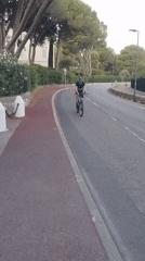 Cycling past the gates of Hôtel du Cap-Eden-Roc, Antibes