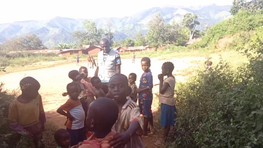 Children gather with adult in Ngalula, DRC