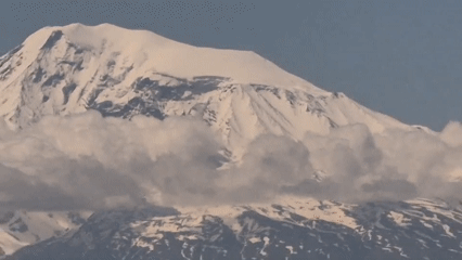 Mountain range and town captured in zoom-out video footage