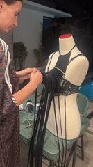Woman crafts macrame garment on mannequin in North Kuta