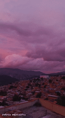 Caracas hillsides glow under a striking pink-purple sunset