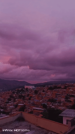 Caracas hillsides glow under a striking pink-purple sunset