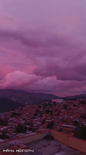 Caracas hillsides glow under a striking pink-purple sunset