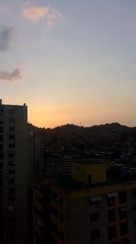 Twilight view captures dense Caracas cityscape from elevated position