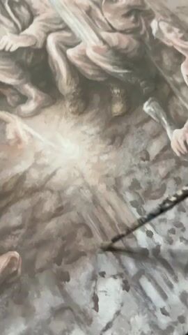 A close-up shot captures a painting in progress. The artwork depicts a scene with multiple figures, some appearing to be in distress or motion, rendered in muted tones of brown, beige, and grey. A paintbrush, held by an unseen hand, is actively applying paint to the lower right portion of the canvas, suggesting the creation of shadows or texture within the composition. A bright, luminous element emanates from the center of the painting, drawing the viewer's eye. The figures in the upper portion of the frame seem to be huddled together, their bodies and clothing detailed, with a sense of urgency conveyed through their poses. The overall impression is one of a dramatic and emotionally charged narrative being brought to life through the artist's brushstrokes.
