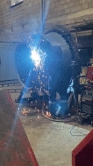 Worker welding metal structure at Montenegro industrial facility