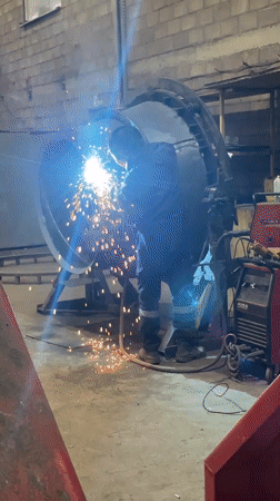 Worker welding metal structure at Montenegro industrial facility
