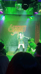 Performer takes stage at Chiang Mai venue with neon signage