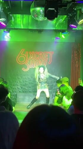 Performer takes stage at Chiang Mai venue with neon signage