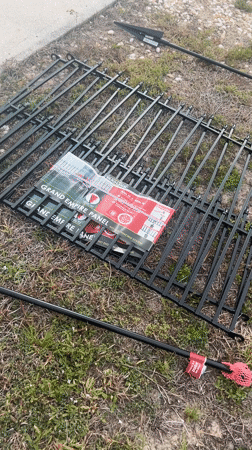 Fence panels await assembly on Cape Coral lawn