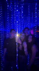 Young adults gather in fairy light decorated room in Mexico