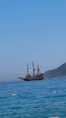 Pirate ship and inflatable raft on Fethiye's calm morning waters