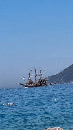 Pirate ship and inflatable raft on Fethiye's calm morning waters