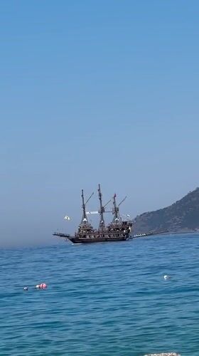 Pirate ship and inflatable raft on Fethiye's calm morning waters