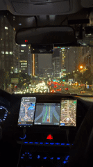 Driver waits at illuminated Seoul intersection at night