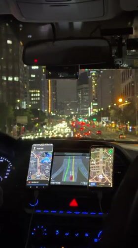 Driver waits at illuminated Seoul intersection at night
