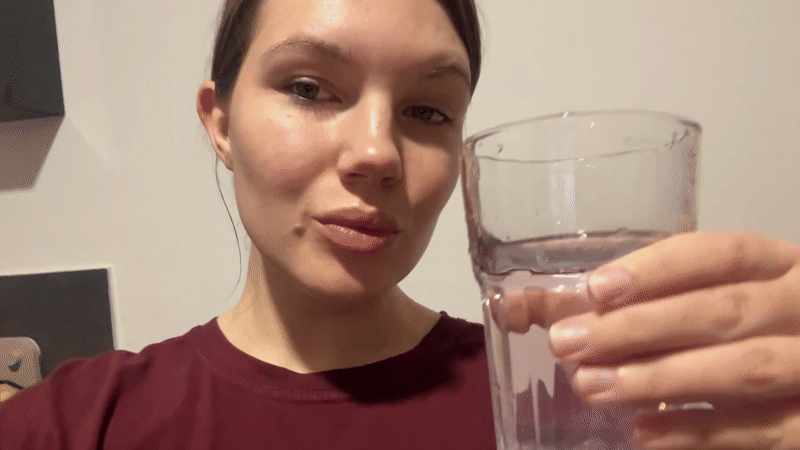 Woman drinks from glass, spills water in Belgrade suburb