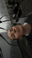 Woman films rainy selfie video with umbrella in Belgrade