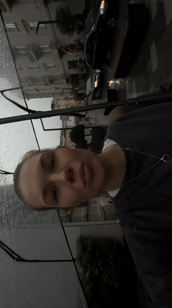 Woman films rainy selfie video with umbrella in Belgrade