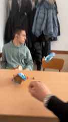 Young men share guilty pleasure snack in Bulgarian classroom
