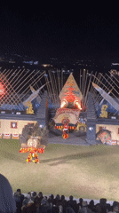 Traditional Javanese performance at a lit outdoor amphitheater, night