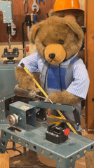 Teddy bear positioned at miniature machine shop in Moscow