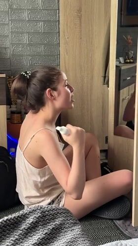 Woman sits on floor examining reflection in Tsarevo mirror