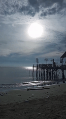 Wooden pier observed under cloudy skies in Lhokseumawe beach