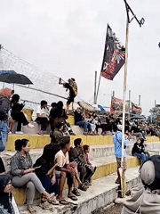 Traditional dancers perform for crowds in outdoor arena, Kuto Indonesia
