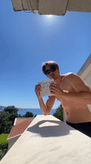 Remote worker displays "work from home" sign on Montenegro balcony