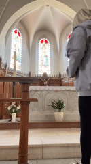Woman documents church interior in Chambœuf, France