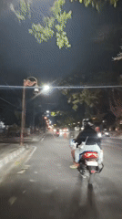 Late-night street traffic moving through Surakarta, Indonesia