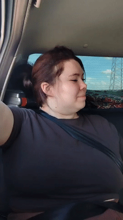 Passengers pose in car backseat in Noviy, Russia
