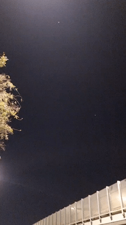 Nighttime street scene captured in Tel Aviv with visible star