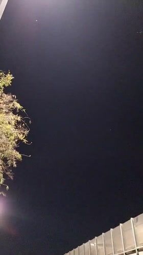 Nighttime street scene captured in Tel Aviv with visible star
