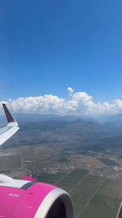 Passenger documents Montenegro landscape during morning flight over Krupice region