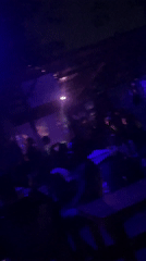 Nightclub interior captured on video showing blue-lit seating area