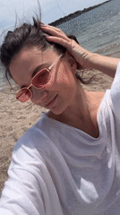 Woman enjoys morning beach visit in Glifada, Greece