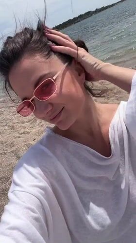 Woman enjoys morning beach visit in Glifada, Greece