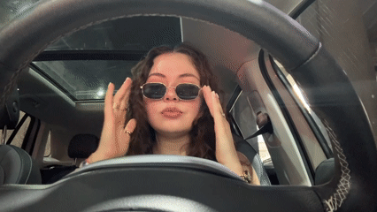 Woman observed adjusting appearance in car driver's seat, Puebla