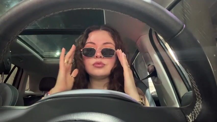 Woman observed adjusting appearance in car driver's seat, Puebla