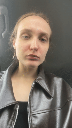 Woman enjoys decorated donut in car in Sharkan