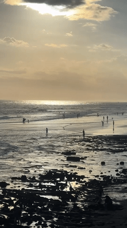 Golden hour beach gathering with surfers in North Kuta